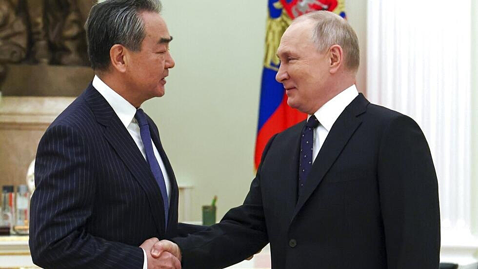 Russian President Vladimir Putin shakes hands with Chinese Communist Party's foreign policy chief Wang Yi during their meeting at the Kremlin in Moscow, Russia, Feb. 22, 2023.-  Copyright  Anton Novoderezhkin, Sputnik, Kremlin Pool Photo via AP